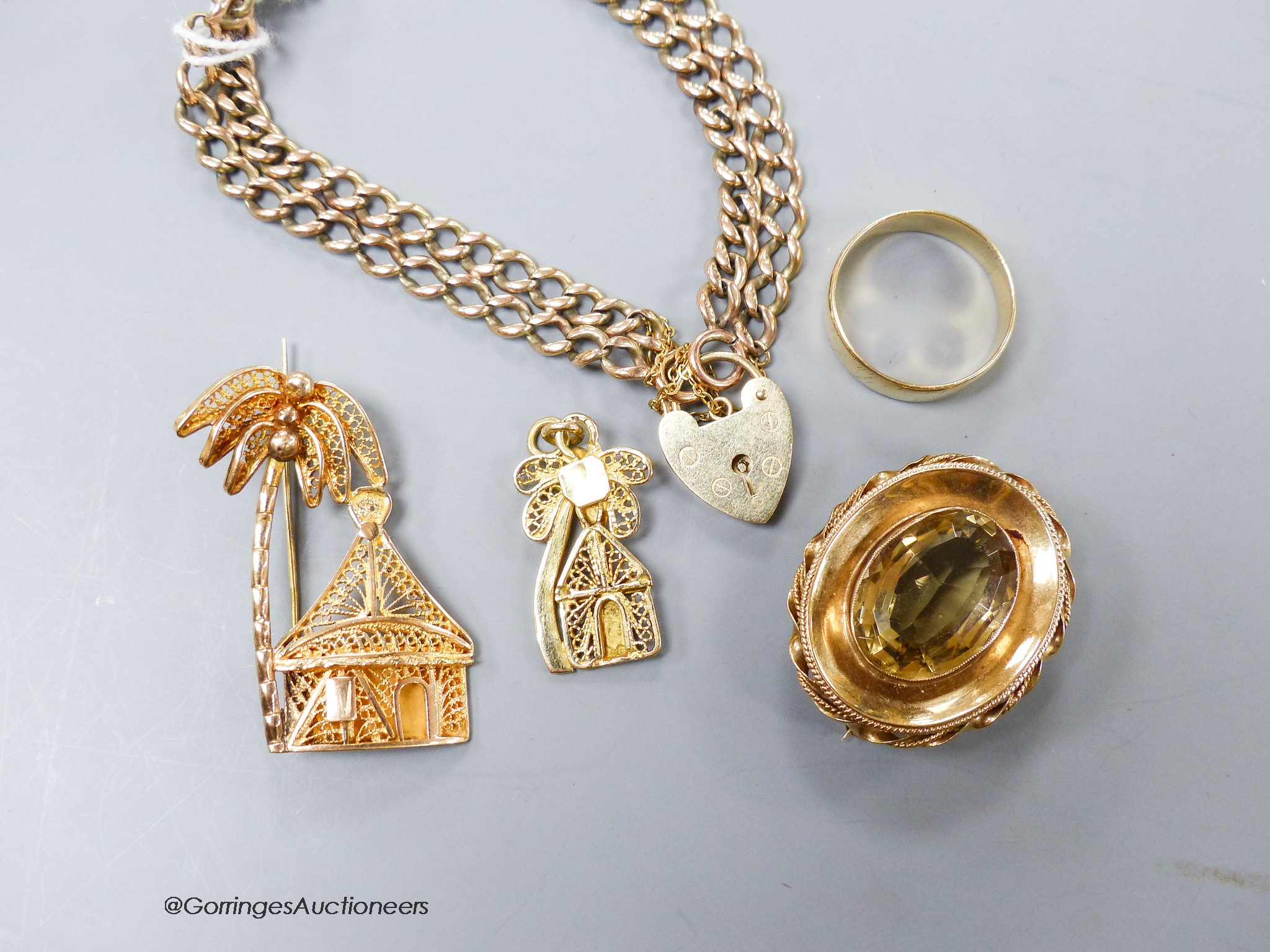 A 9ct gold bracelet, a 9ct filigree pendant and brooch, a 9ct and citrine brooch and a yellow metal wedding band